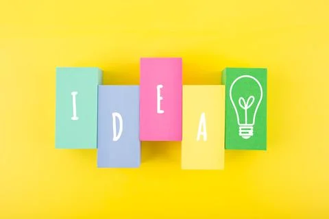 Creativity and idea concept. Single word idea and light bulb drawn on Stock Photos
