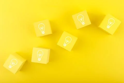 Creativity, brainstorming and fresh ideas concept. Light bulbs drawn on toy Stock Photos