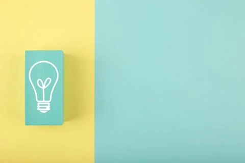 Creativity concept. Light bulb drawn on rectangle on yellow and blue background 스톡 일러스트