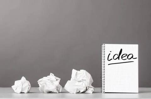 Creativity creative process. crumpled wads and notebook with word idea Cop... 库存照片