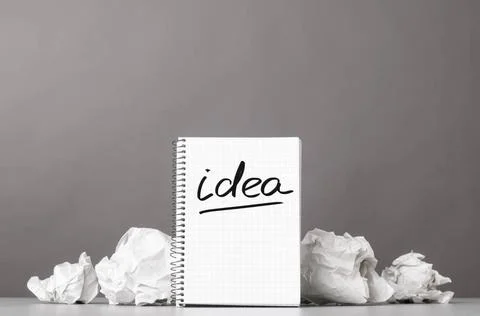 Creativity creative process. crumpled wads and notebook with word idea Cop... 库存照片