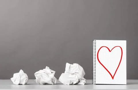 Creativity creative process. crumpled wads and notebook with heart picture... Foto stock
