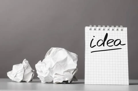 Creativity creative process. crumpled wads and notebook with word idea Cop... Stock Photos