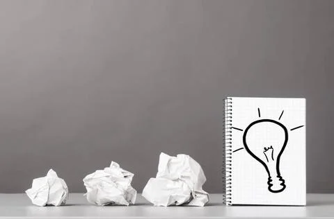 Creativity creative process. crumpled wads and notebook with bulb picture ... Foto stock