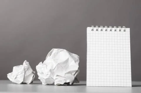 Creativity creative process. crumpled wads and notebook on gray Copyright:... Foto stock