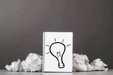 Creativity creative process. crumpled wads and notebook with bulb picture ... Fotos de archivo