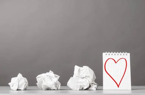 Creativity creative process. crumpled wads and notebook with heart picture... Stockfoto's