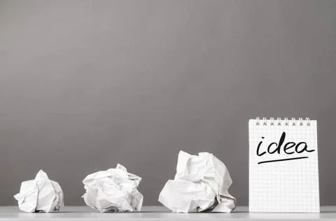 Creativity creative process. crumpled wads and notebook with word idea Cop... Fotos de archivo