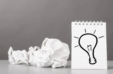 Creativity creative process. crumpled wads and notebook with bulb picture ... Stockfoto's