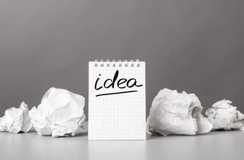 Creativity creative process. crumpled wads and notebook with word idea Cop... Fotos de archivo