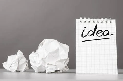 Creativity creative process. crumpled wads and notebook with word idea Cop... Stockfoto's