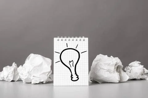 Creativity creative process. crumpled wads and notebook with bulb picture ... Fotos de archivo