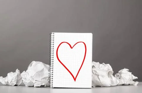 Creativity creative process. crumpled wads and notebook with heart picture... Foto stock