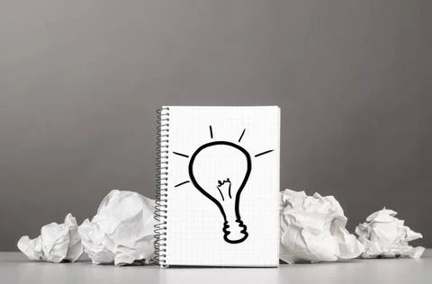 Creativity creative process. crumpled wads and notebook with bulb picture ... Stockfoto's