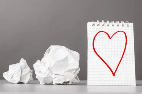 Creativity creative process. crumpled wads and notebook with heart picture... Foto stock