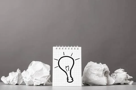 Creativity creative process. crumpled wads and notebook with bulb picture ... Stockfoto's