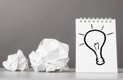 Creativity creative process. crumpled wads and notebook with bulb picture ... Fotos de archivo