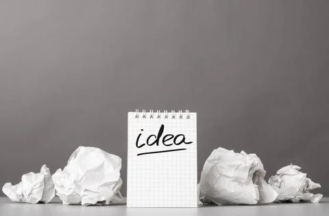 Creativity creative process. crumpled wads and notebook with word idea Cop... Stockfoto's
