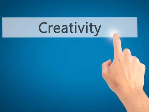 Creativity - Hand pressing a button on blurred background concept on visual s Stock Photos