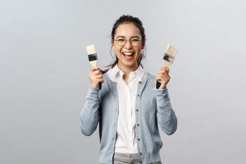 Creativity, repairs and overhaul concept. Excited happy, smiling asian woman Stock Photos