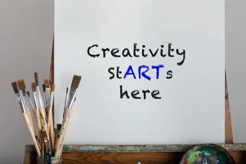 Creativity starts here message painted in black paint on white canvas Stock Photos