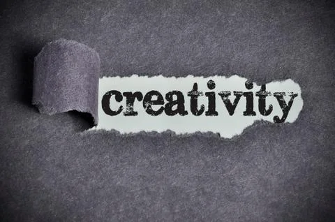 Creativity  word under torn black sugar paper Foto stock