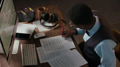 Creator in Formalwear Taking Notes on Papers with Essays at Table with PC Stock Footage 306925686