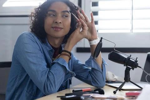 Creator shaping brows at home desk mic, pressing record and showing animated Stock Photos