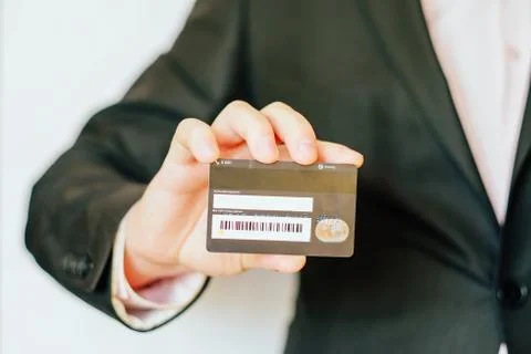Credit card CVV2 code. man holding plastic card. Stock Photos