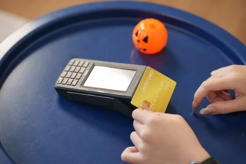 Credit card payment transaction processed on terminal machine over table Stock Photos