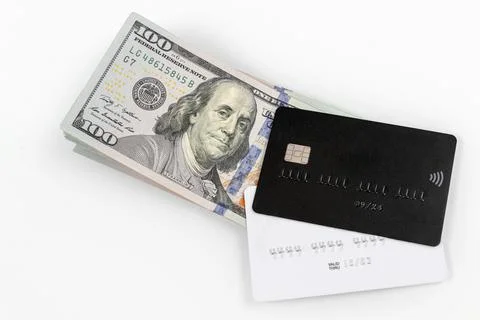 Credit cards on stack of hundred-dollar bills. Black and white credit cards.  Stock Photos