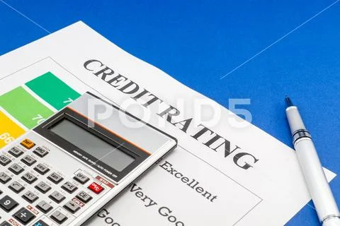 Credit rating on a blue table, pen. Stock Photos