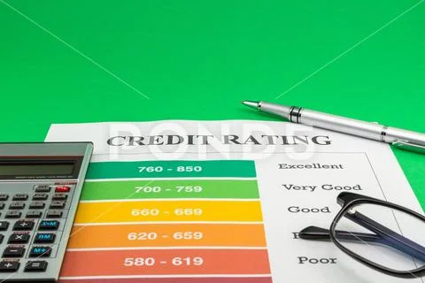 Credit rating on a green table, pen and calculator. Stock Photos