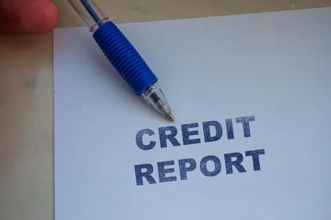 Credit report document on white desk with blue ballpoint pen pointing at bold Stock Photos