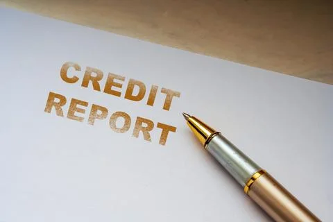 Credit report document on white paper with gold ballpoint pen, concept of Stock Photos