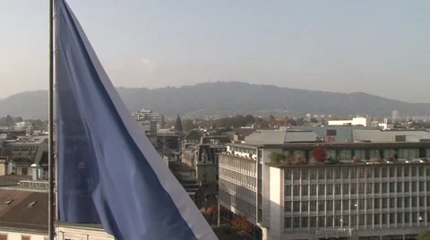 Credit Suisse at Paradeplatz and Zurich flag, Pan Stock Footage
