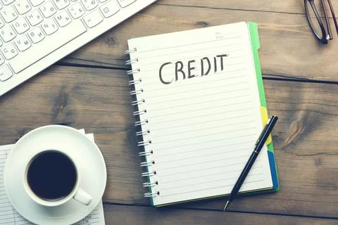 Credit  text written on a notebook. Stock Photos