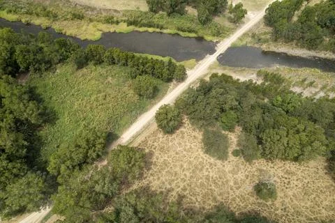 Creek And Road Through Green Country Landscape Stock Photos