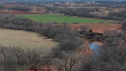 Creek Bend Flowing Through Mixed Farmland With Green Field Aerial Oklahoma Stock Footage 329192572