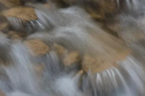 Creek with Brown Rocks Stock Photos