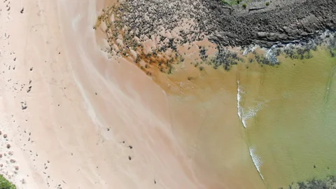 A creek feeds into the ocean Stock Footage 154563235