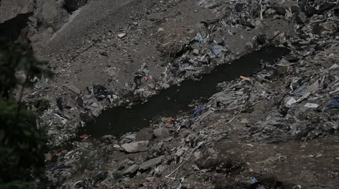 Creek flowing through dump in Guatemala Stock Footage 61158083