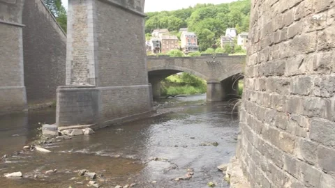 Creek Flowing under Stone Bridge in Belgium or Europe Stock Footage 325265353