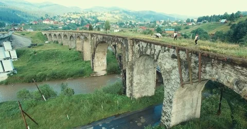 Creek under old arched bridge Stock Footage 77935205