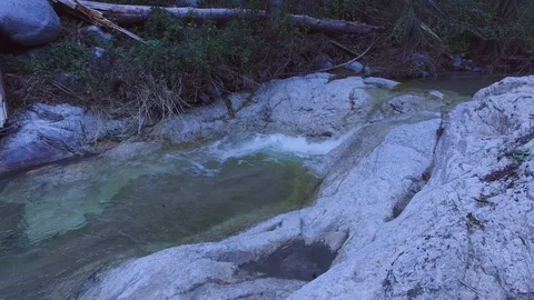 Creek with water flowing down stream 動画素材 73436918