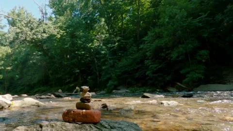 Creek water rushing by a stone stack Stock Footage 169129708