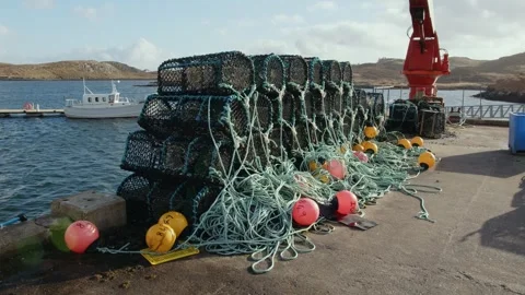 Creels stacked at Bernera pier on the Outer Hebrides Stock Footage 332134994