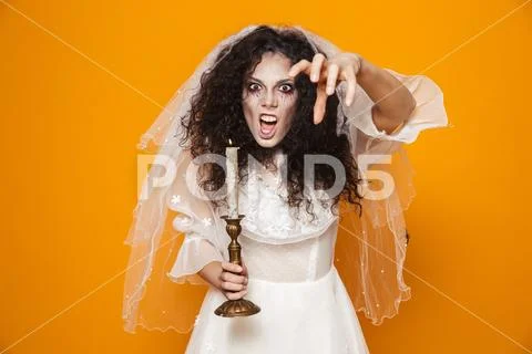 Creepy bride scary to camera and holding candle isolated Stock Photos
