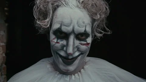 Creepy Clown with Axe Looking at Camera Stock Footage 250959898