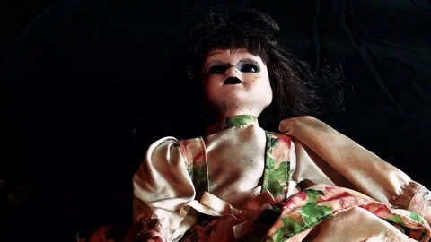 Creepy doll lays down front shot 動画素材 106078375